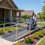 Residential front entrance with compliant wheelchair ramp, handrails, landing and a person in a wheelchair using the ramp
